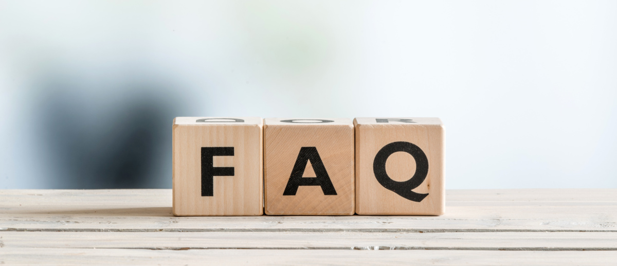 FAQ sign made of wood on an office table